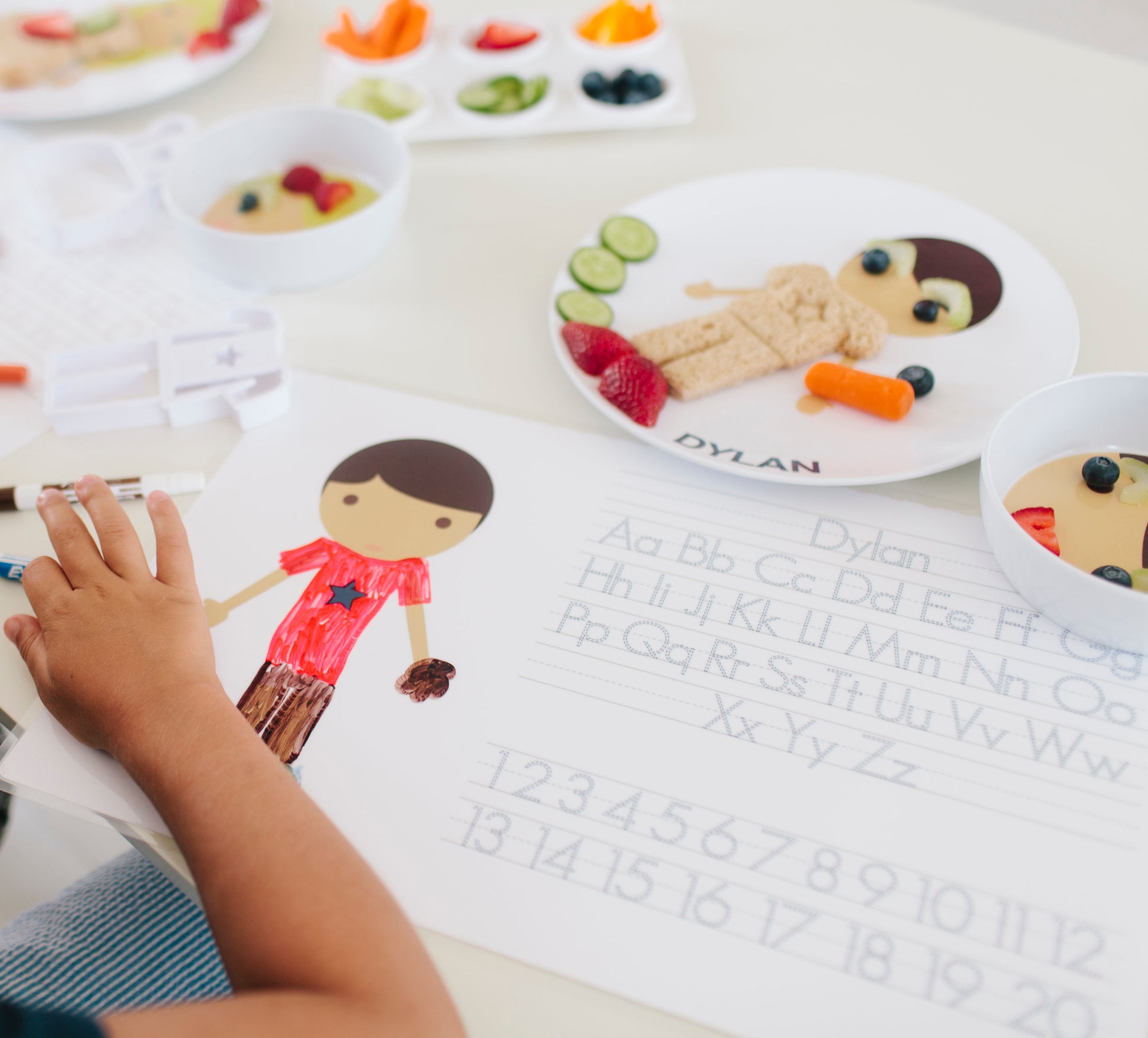 Little boy using the activity side of his double sided little me boy placemat
