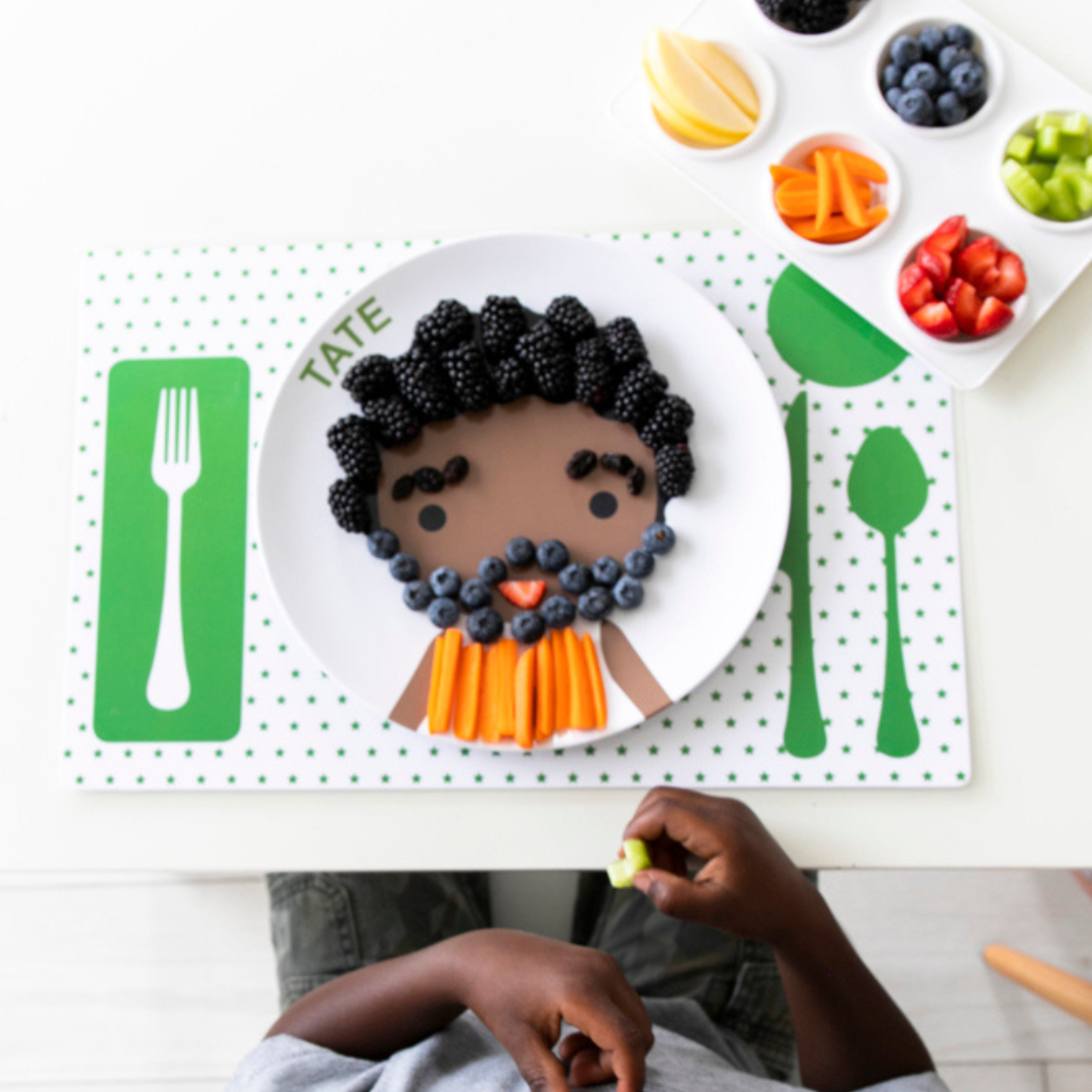 little boy decorating his dylbug personalized little me placemat with fruit and veggies make meal times fun