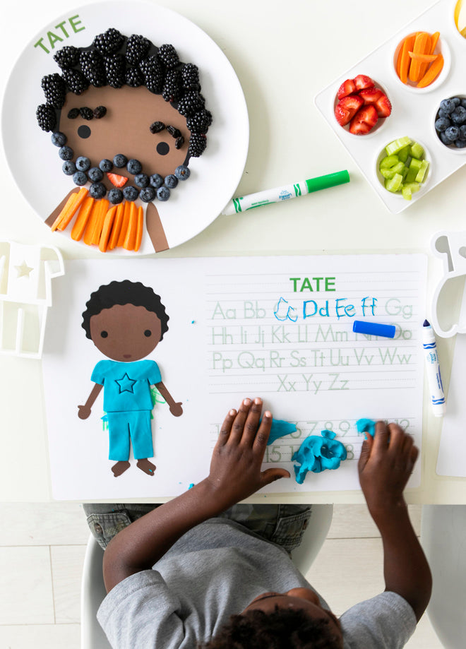 little boy use his dylbug personalized little me placemat on the activity side