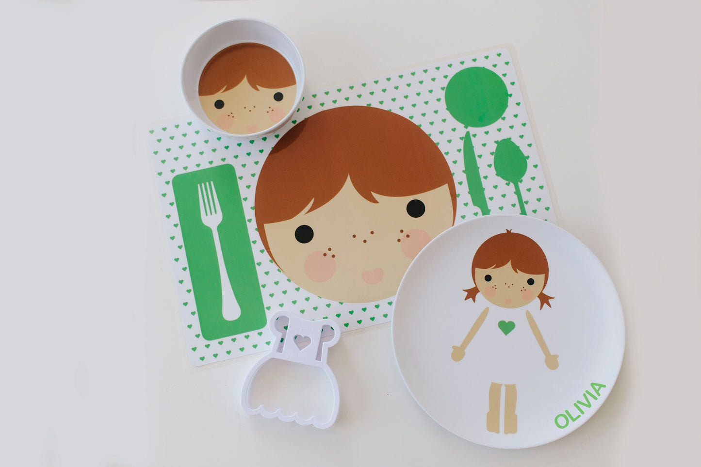 Dylbug personalized little me girl dish set in green. Including placemat, plate, bowl and food cutter. Customize skin tone, hair color, hair style, eye color,  add glasses and freckles.