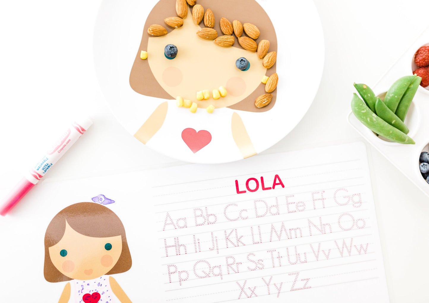 Dylbug personalized placemat in pink. Placemat is double sided including an activity side with letter tracing and customized face side.