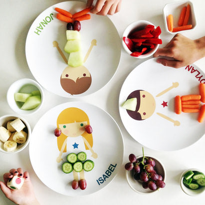 Kids using fruit and veggies to dress up and decorate their personalized little me boy and little me girl plates. Having fun at meal time!